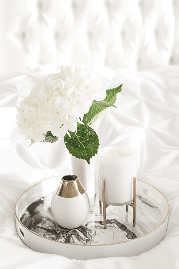 white candle and flowers