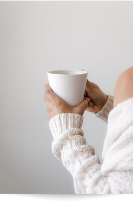 A person holding a cup of coffee